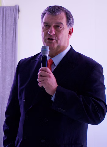Mike Rawlings speaking with a microphone during his early years as Dallas mayor