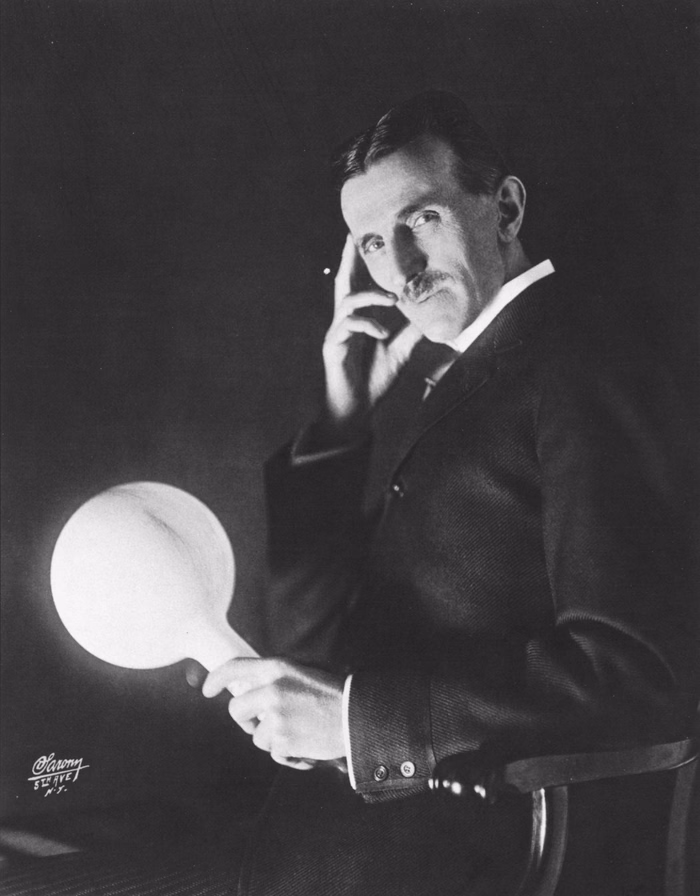 Nikola Tesla holding a wireless-powered lightbulb in a 1898 studio portrait by Napoleon Sarony