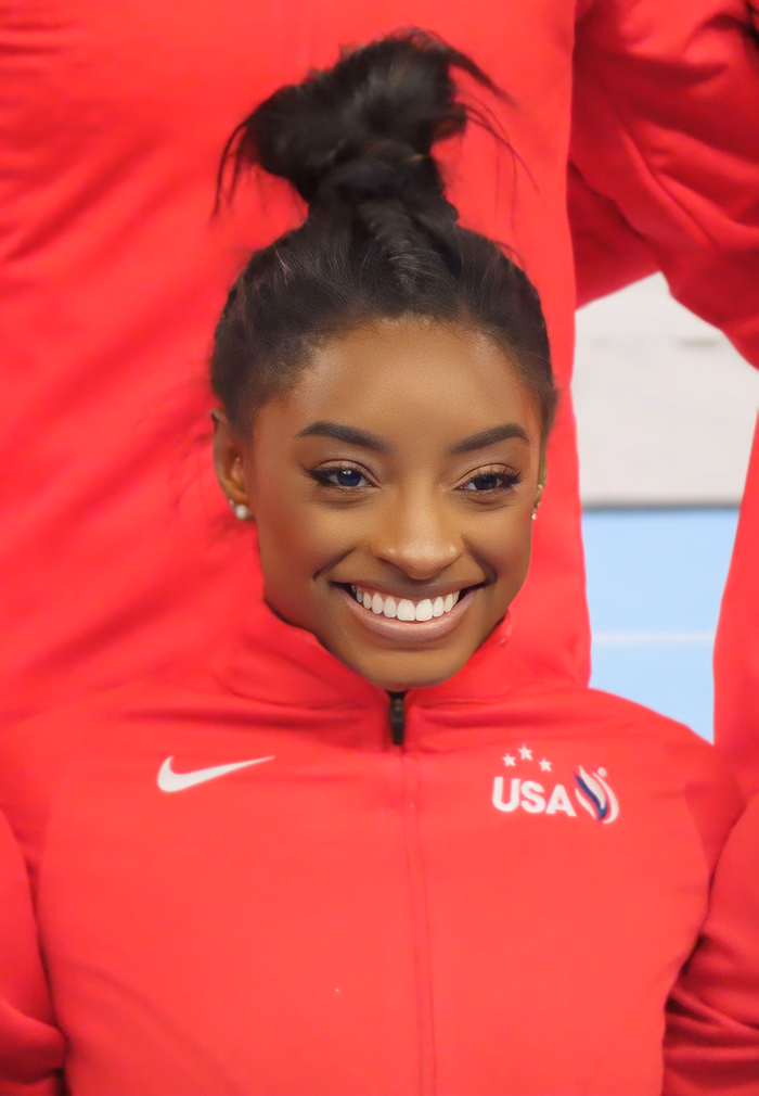 Simone Biles smiling in Team USA gymnastics gear in 2024